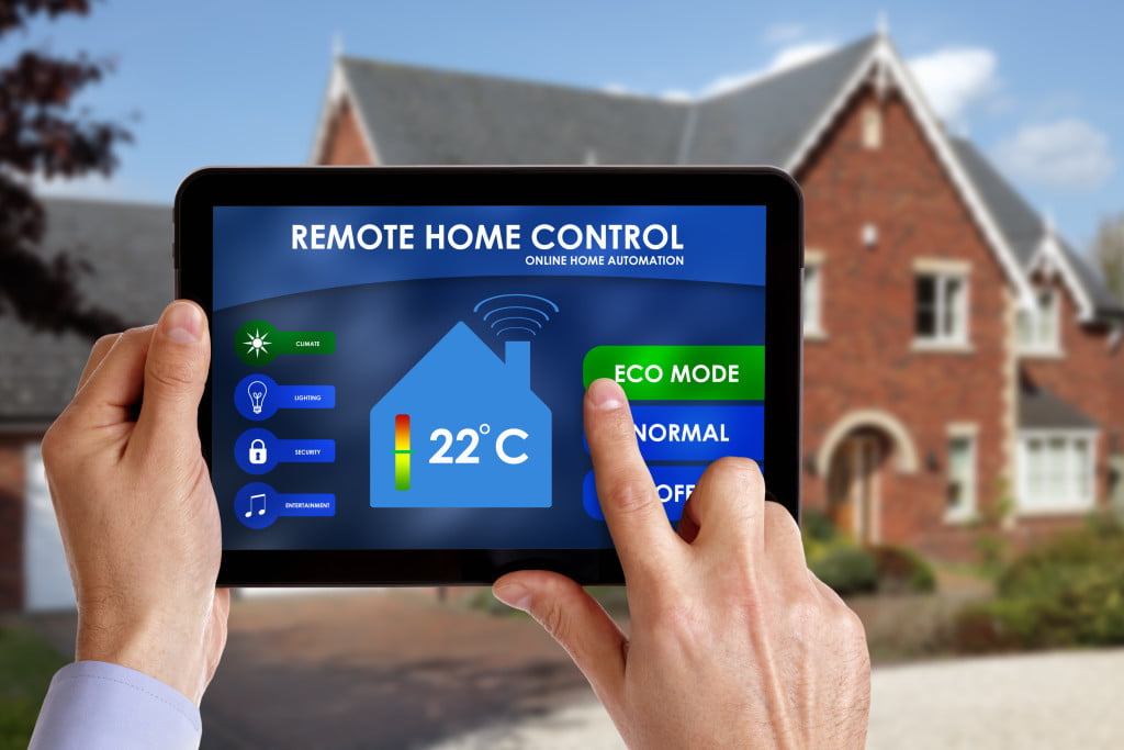 person holding a tablet that controls the house