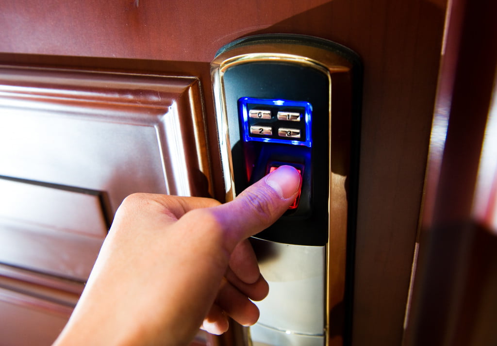 A hand using biometrics to open a door